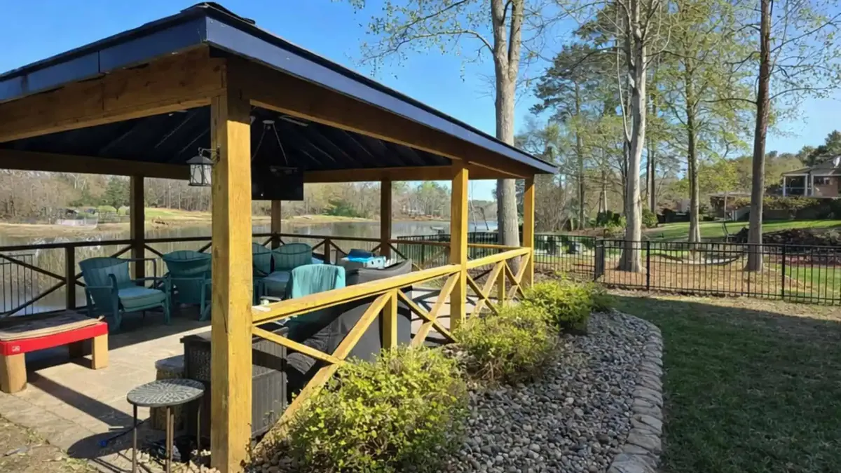 Covered pavilion surrounded by fresh landscaping and a manicured lawn